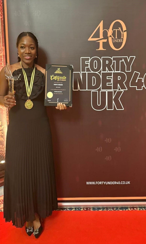 Woman standing, holding an award