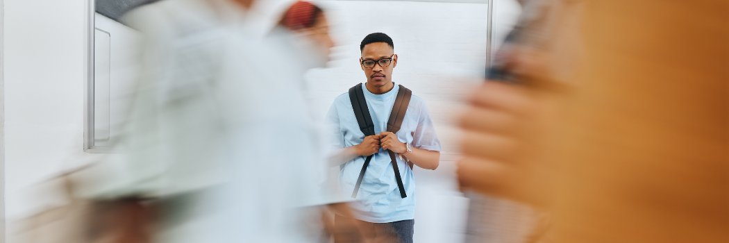 Lonely man standing in a crowd