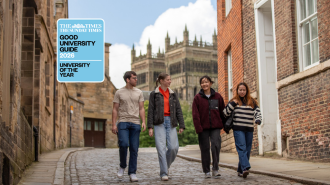 An image of a mixed group of students walking down a cobbled street with Durham Cathedral in the background. A logo with 'University of the Year' is positioned to the top left of them.