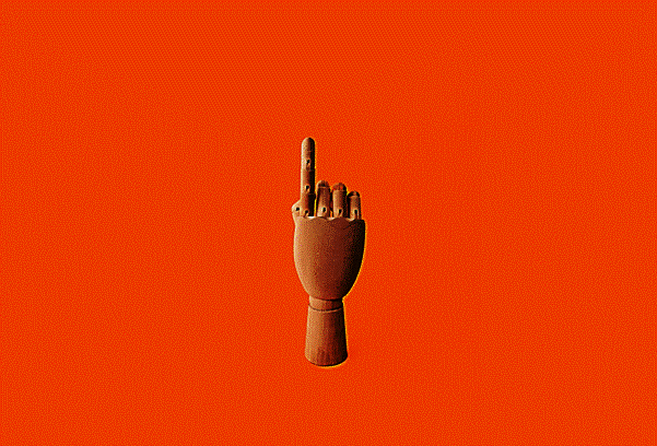 wooden hand pointing upwards against orange background