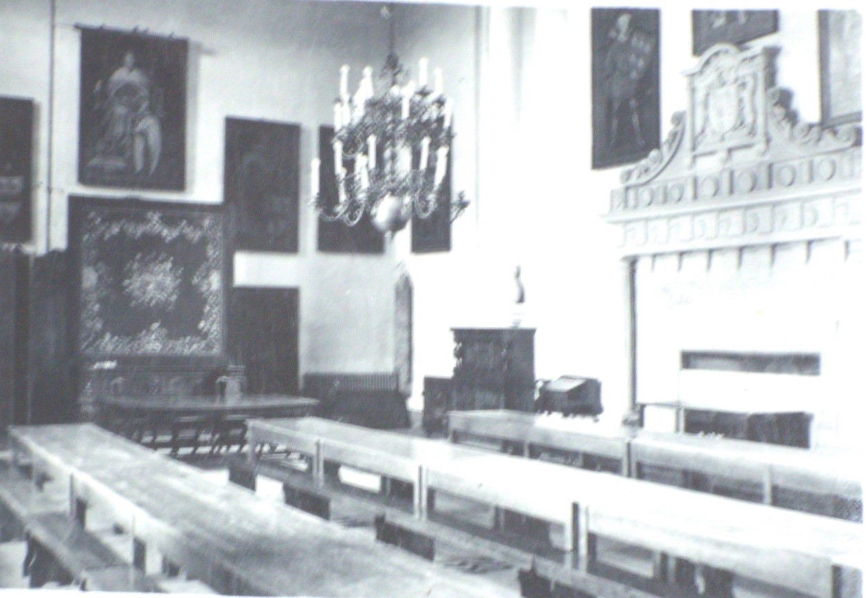 A black and white images showing long wooden tables and a grand fireplace in Lumley Castle