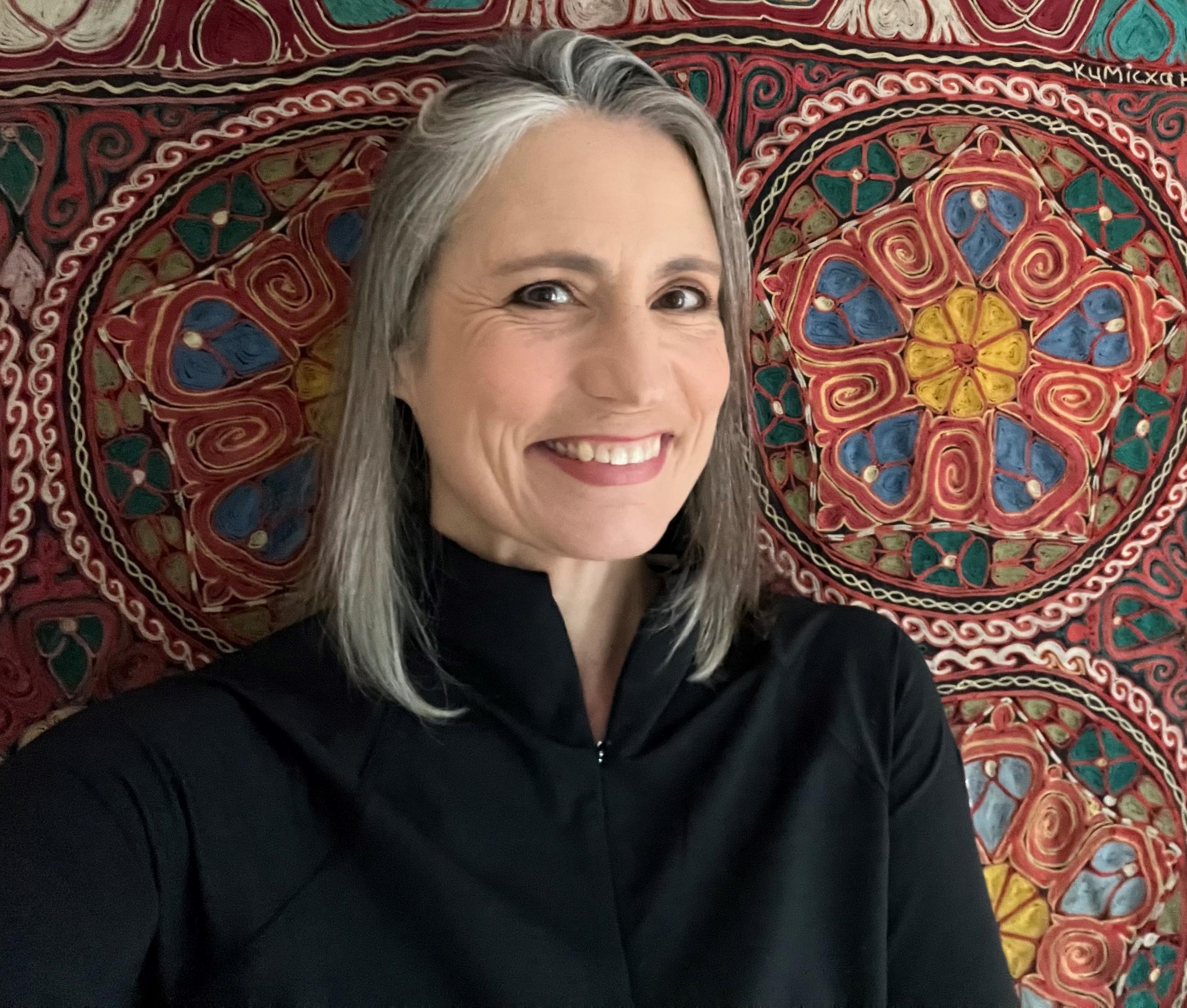 Fiona Hill in front of tapestry