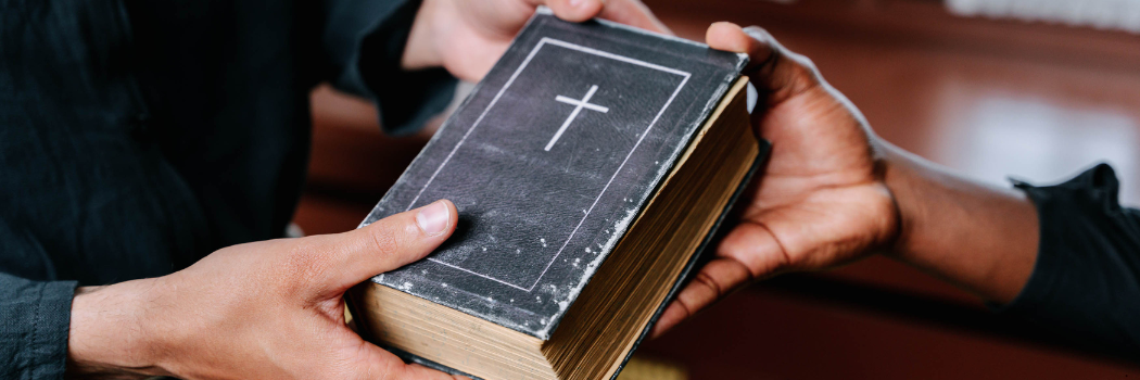 Two hands holding a Bible.
