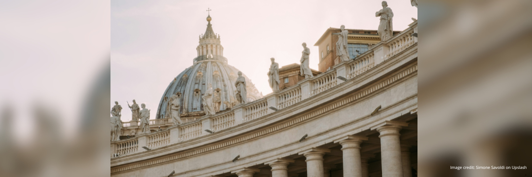 Image of St Peter's Basilica in Vatican City with the sun lighting part of the dome