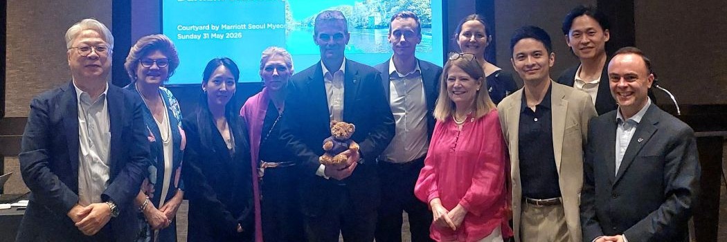 A group of people standing together at an event with Durham bear