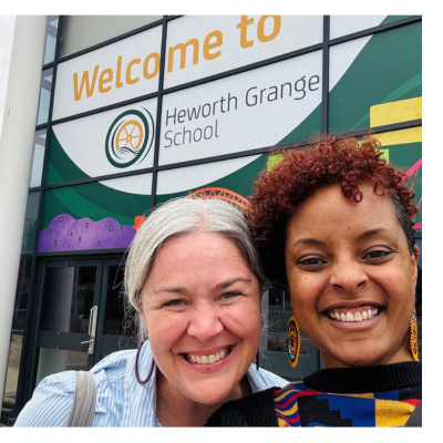 Amanda Herbert with Ebony Iman Dallas both smiling in front of Heworth School
