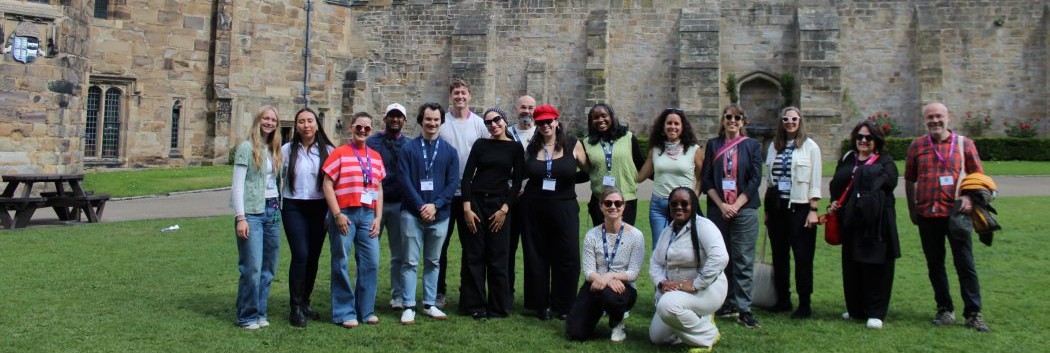 A group of students standing in front of Durham Castle.