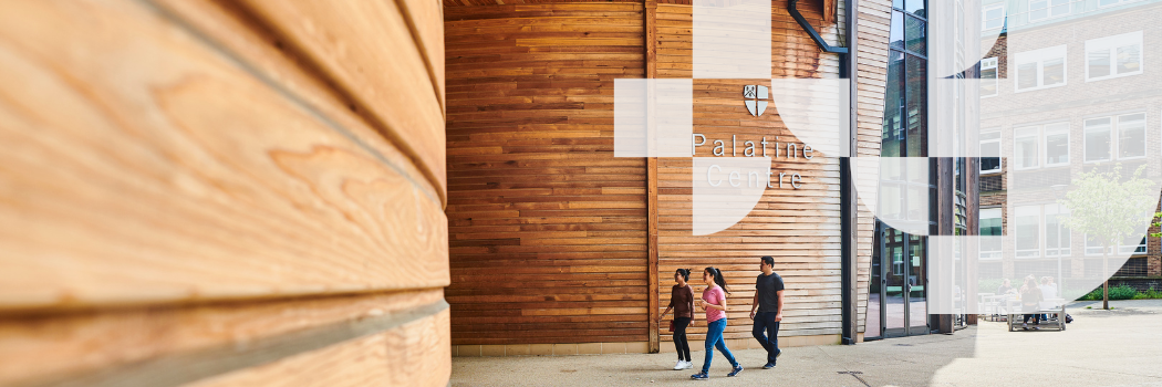 Three students walking into a large building.
