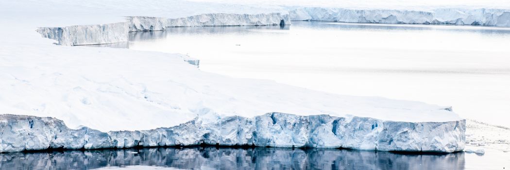 An ice sheet juts out into the ocean.