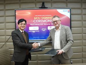 VC of Manav Rachna University India shaking hands with Professor Martin Evans SS India visit MOU signing