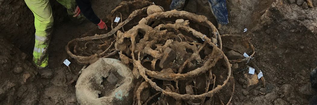 Tangled metal in an excavation trench in the ground