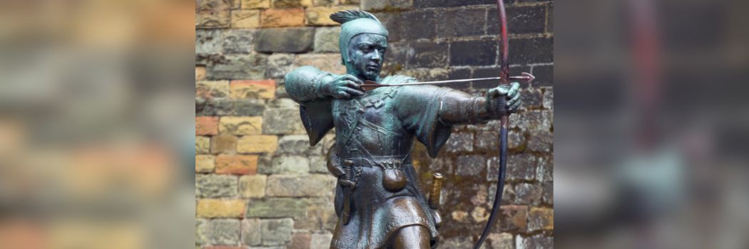 A statue of Robin Hood firing an arrow from a bow