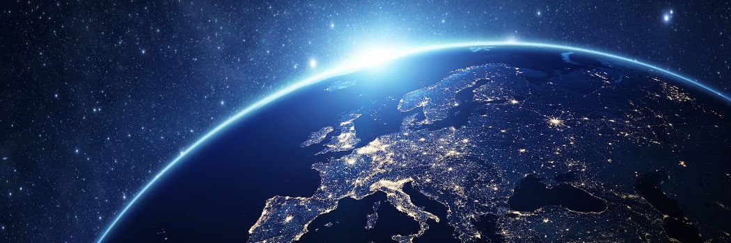 An image of the curve of the Earth from space showing the UK and Europe. Sunlight is peering over the Earth's curve.