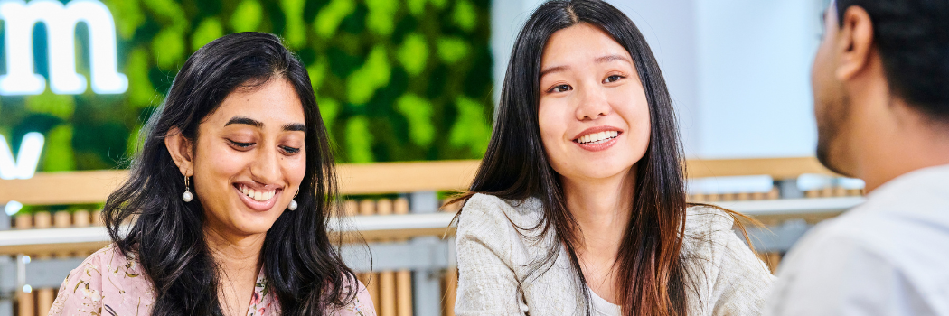 Two students smiling in conversation