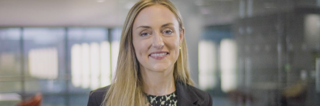 Dr Katie Harland-Edminson in suit smiling at camera