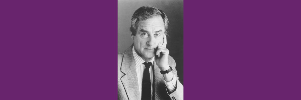 A black and white photo of an older man in a short and tie, resting his chin on his hand