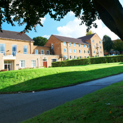 Grey College across the lawn on a sunny day