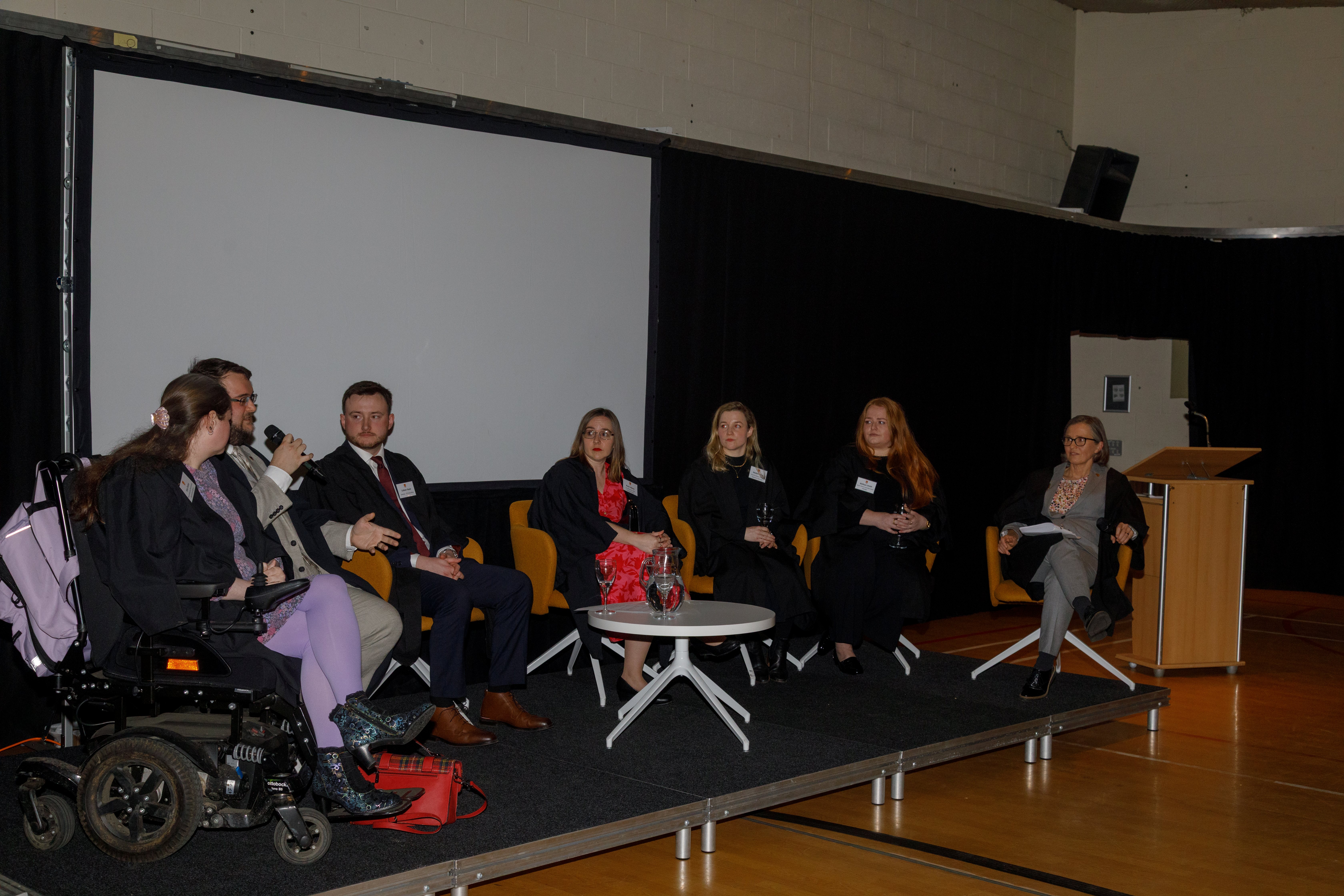 alumni panel sat on stage in a Q&A session
