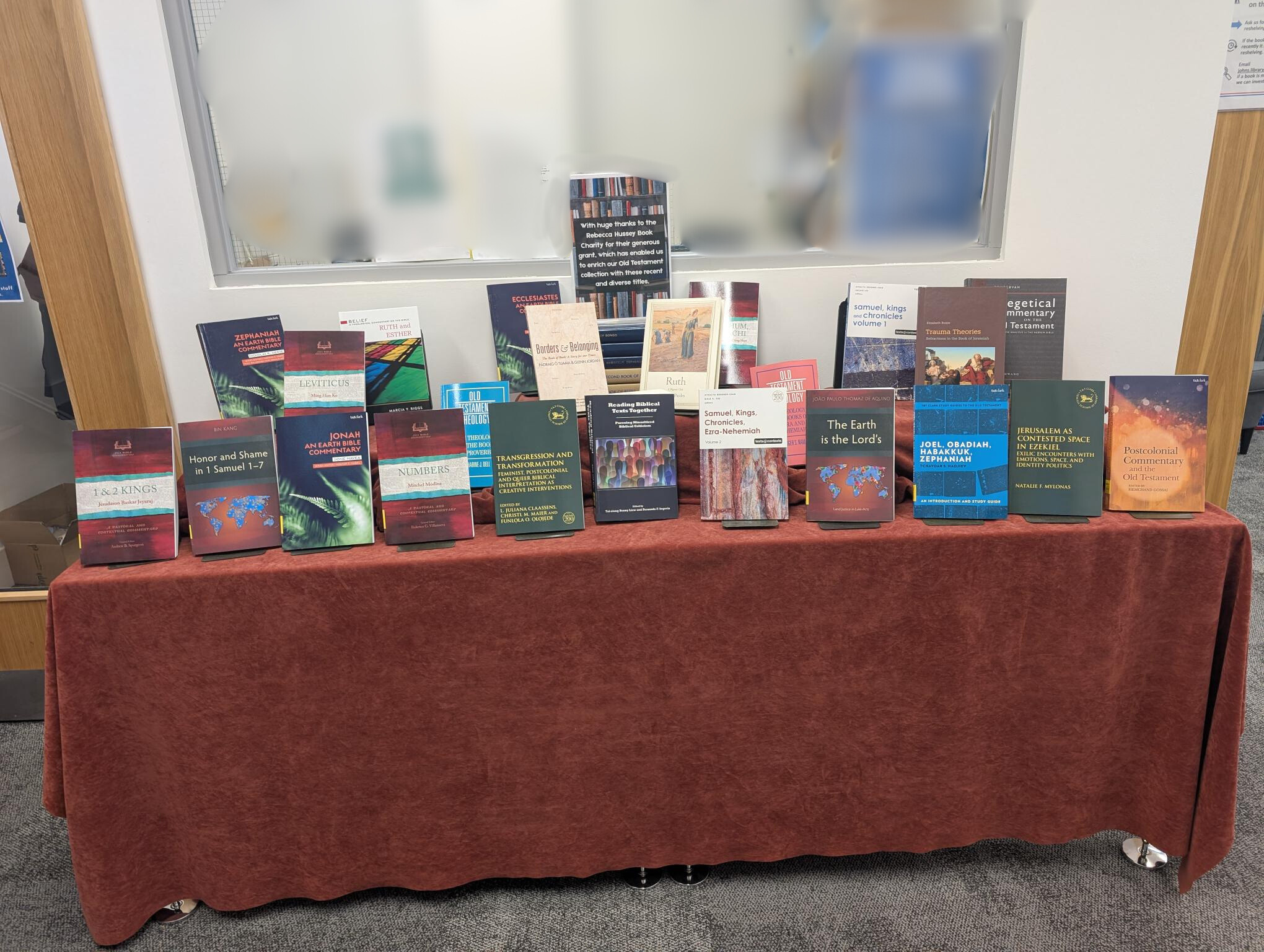 Books displayed on a red table