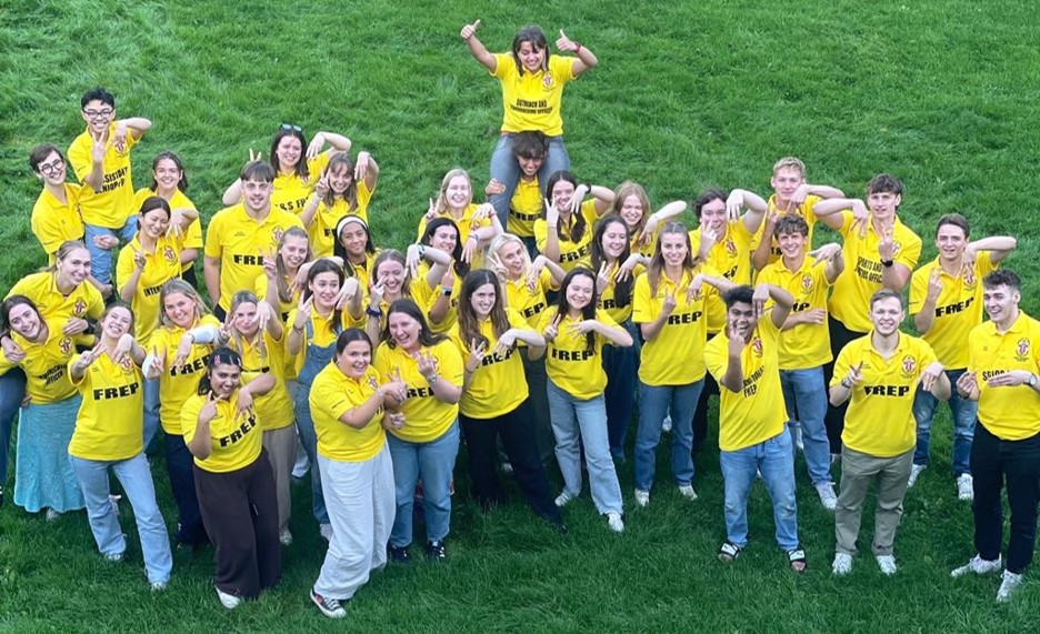 Van Mildert Freps in yellow shirts making V and M signs for Van Mildert