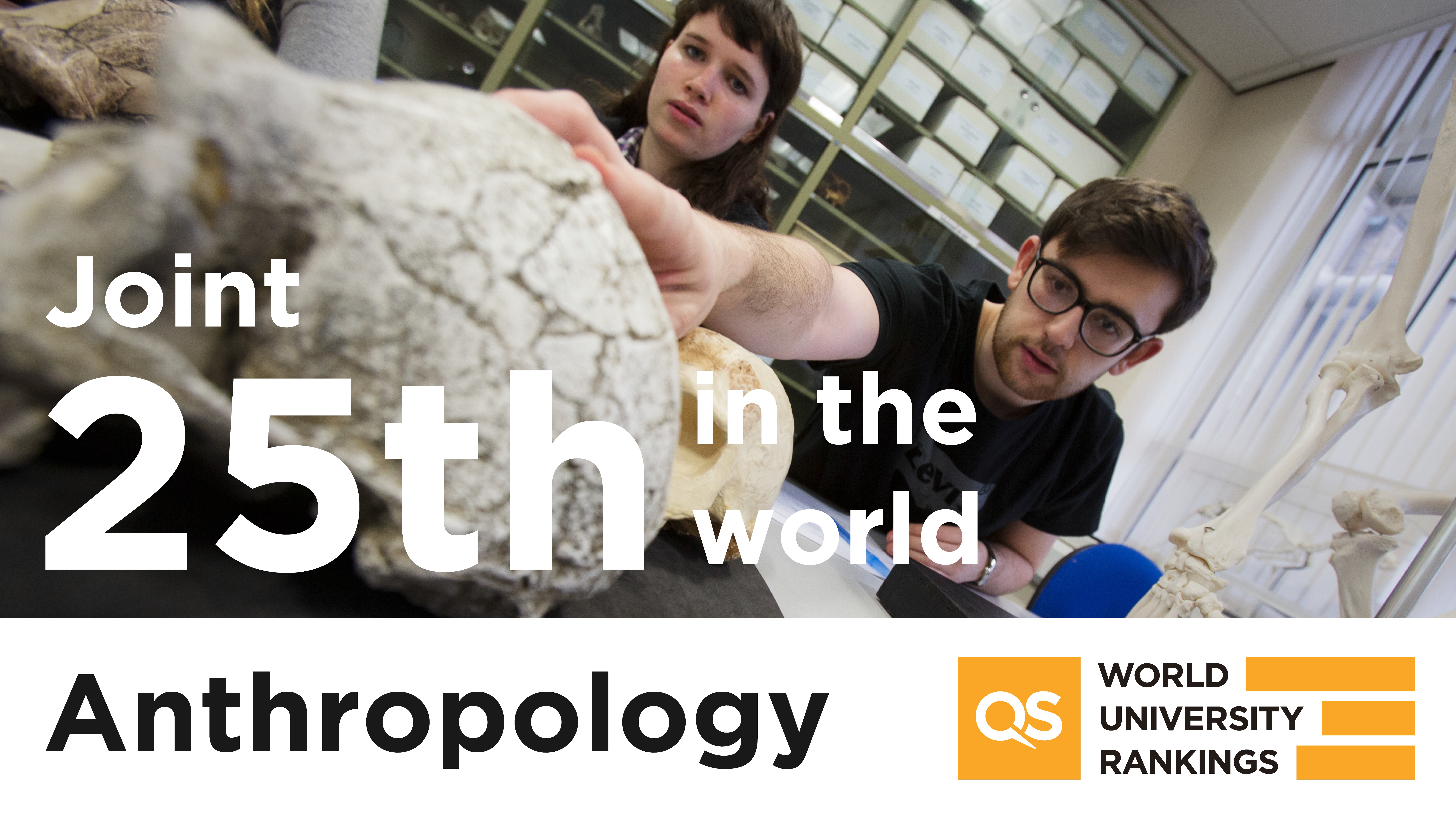 Background. Two university students, one male and one female, observe skeletal remains in an Anthropology lab. Foreground, text stating, Joint 25th in the world, Anthropology, QS World University Rankings.