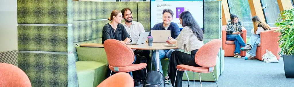 Group of mature students meeting around a table