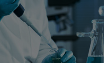 Partial view of a person using chemistry equipment