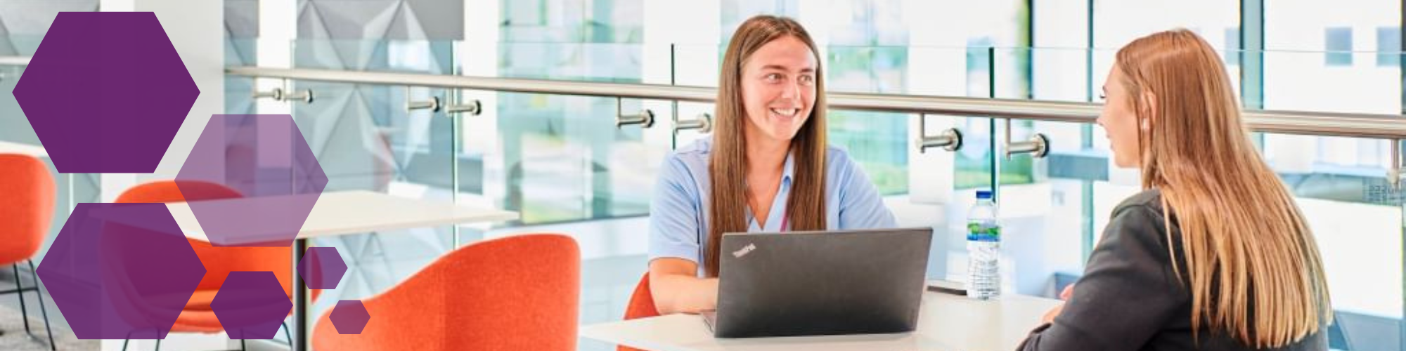 Two young professionals in meeting sitting at a table