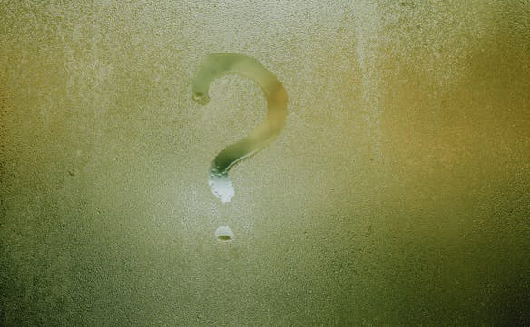 Question mark drawn in the moisture on a window