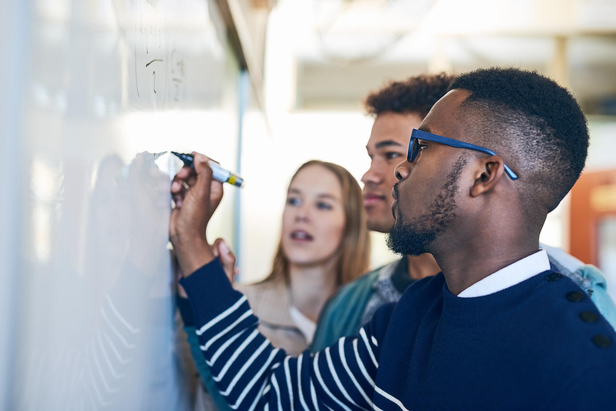 Students writing on whiteboard