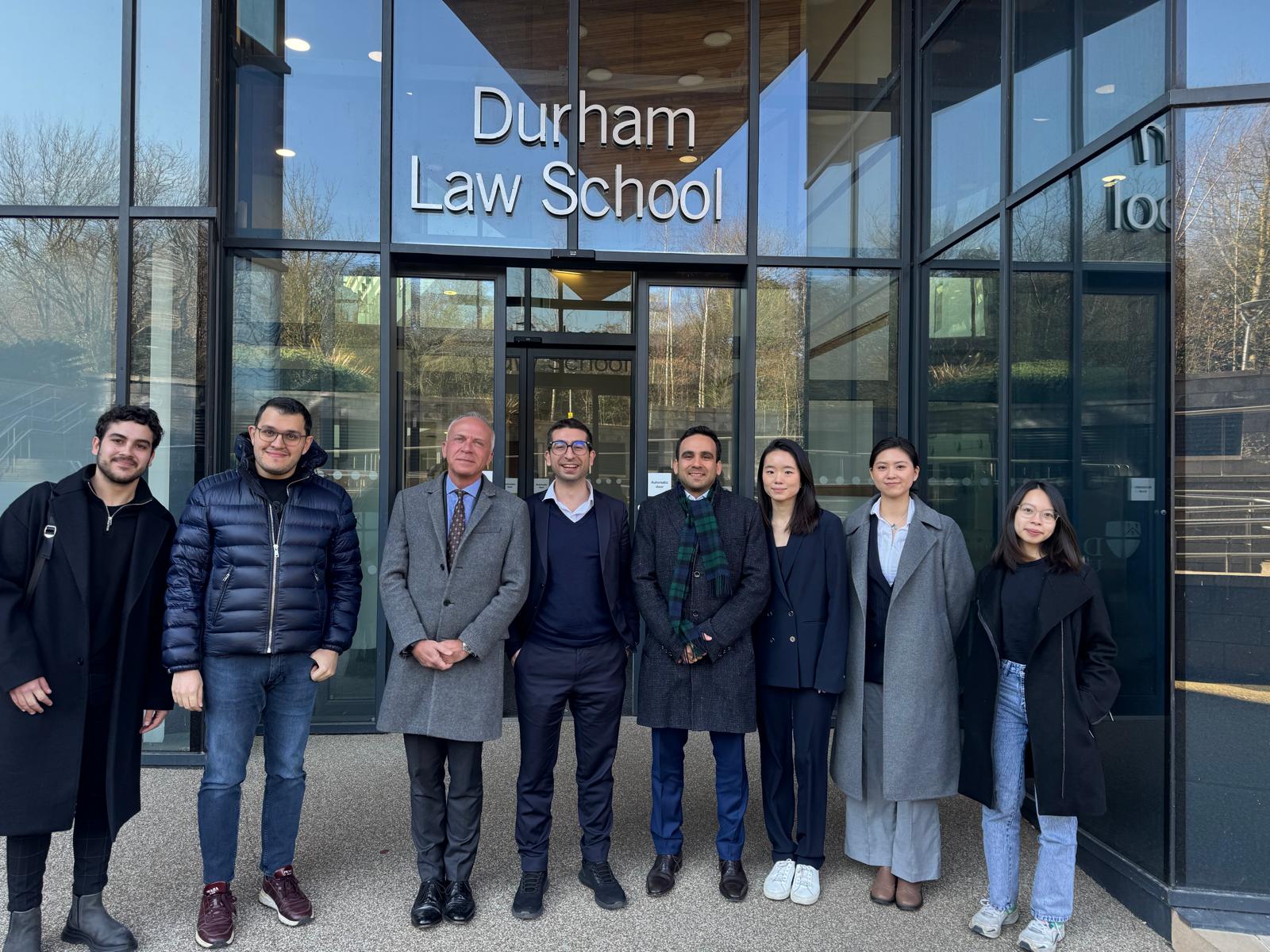 A group of people standing outside Durham Law School
