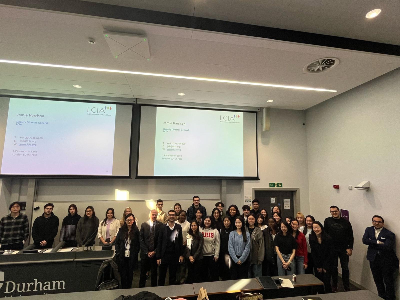 A group of people in front of a PowerPoint slide
