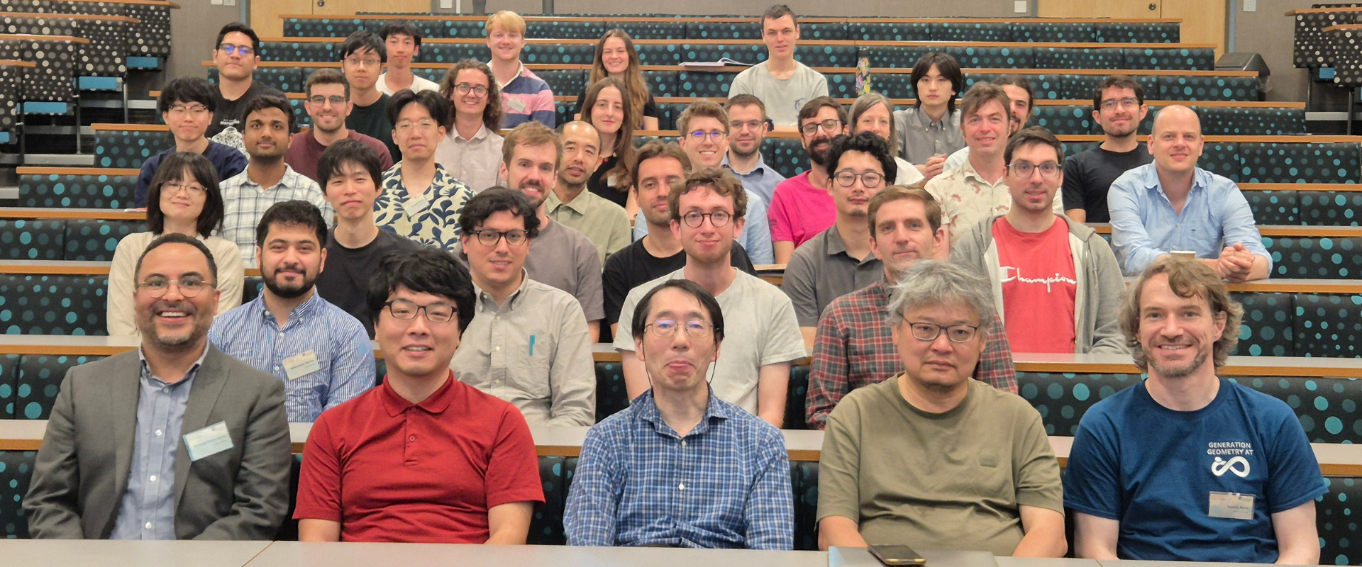 Symposium participants sitting in lecture hall.