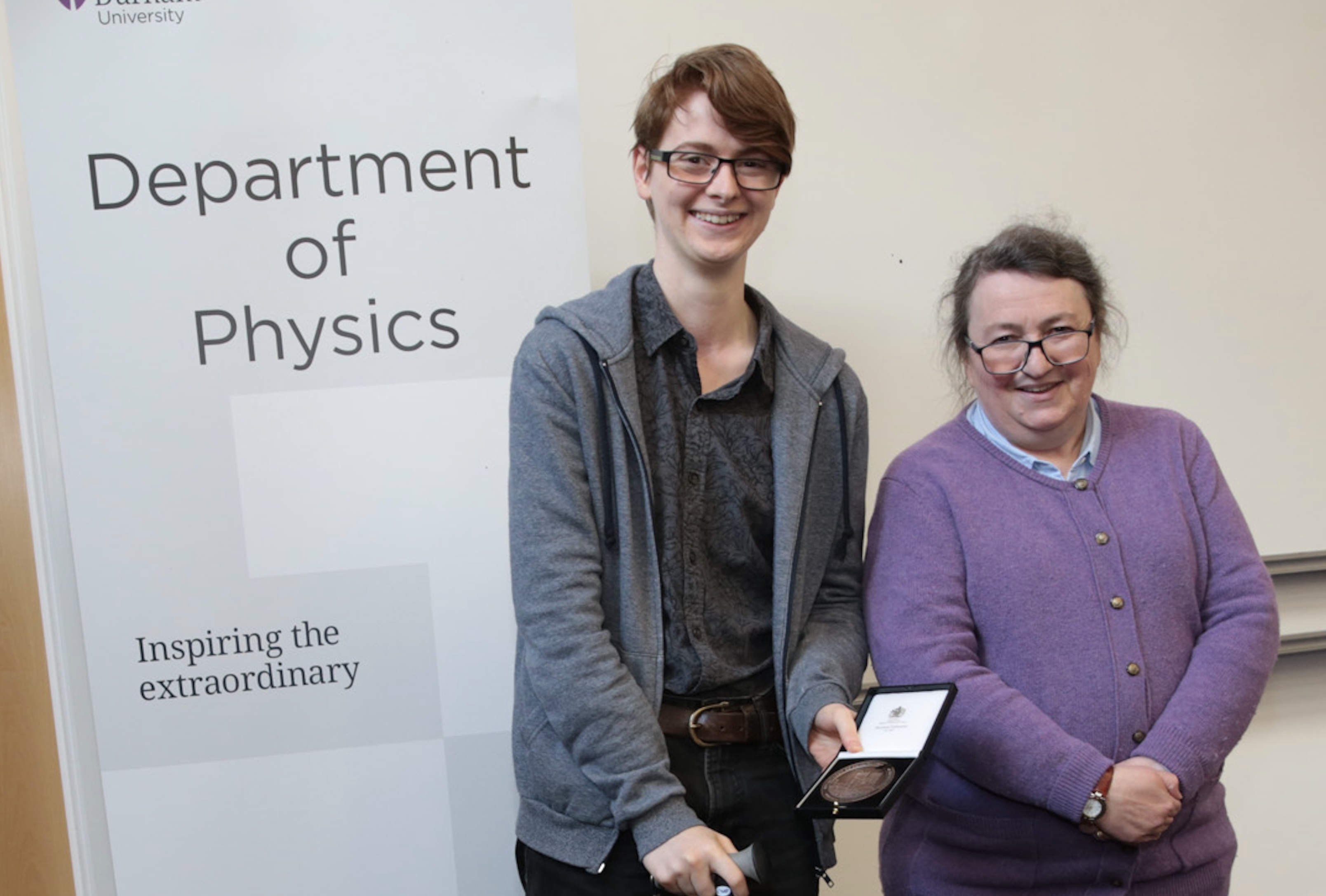 Ery McPartland receiving a staff excellence award from Paula Chadwick