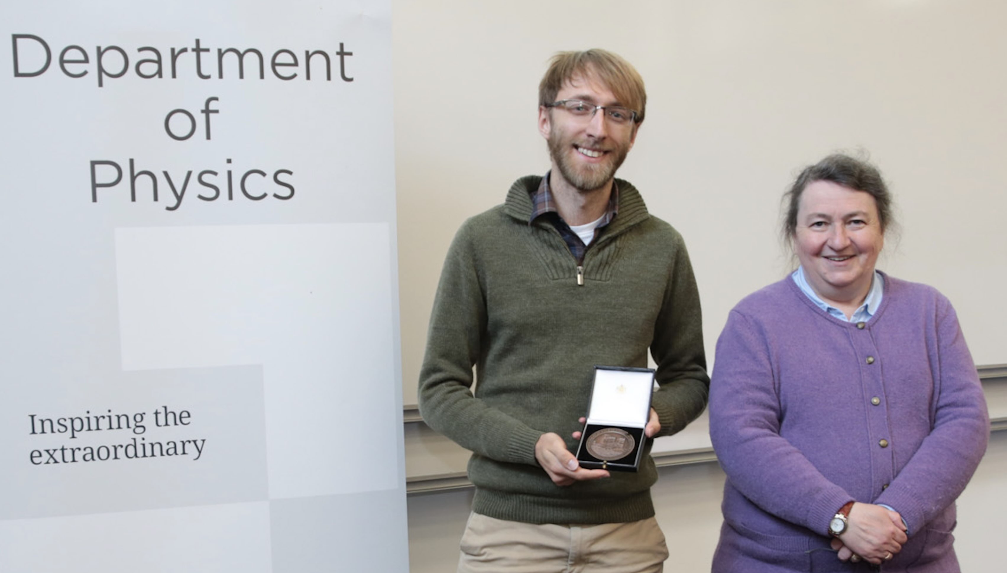 Jonathan Mortlock receiving a staff excellence award from Prof Paula Chadwick