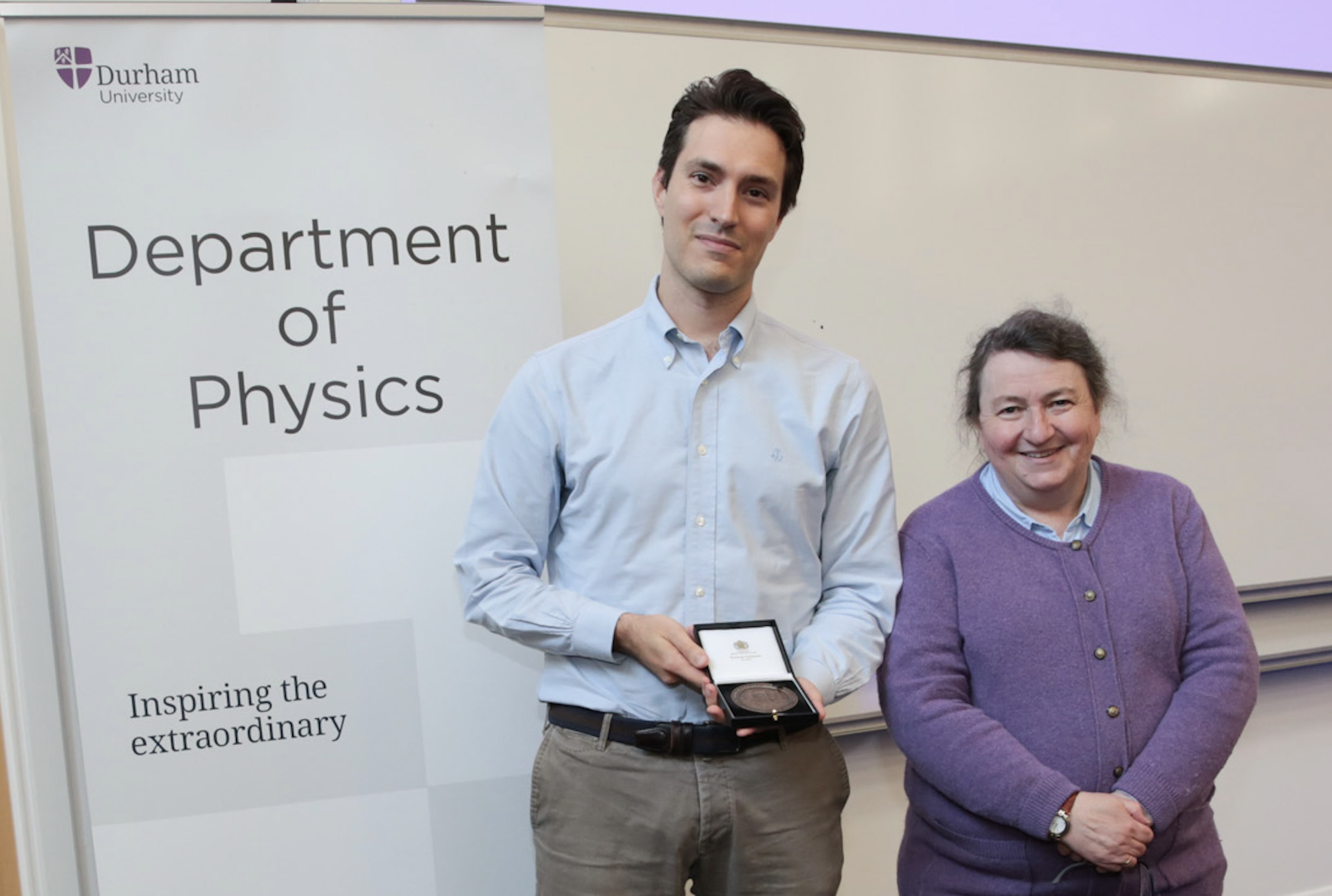 Matteo Marcoli receiving a staff excellence award from Prof Paula Chadwick