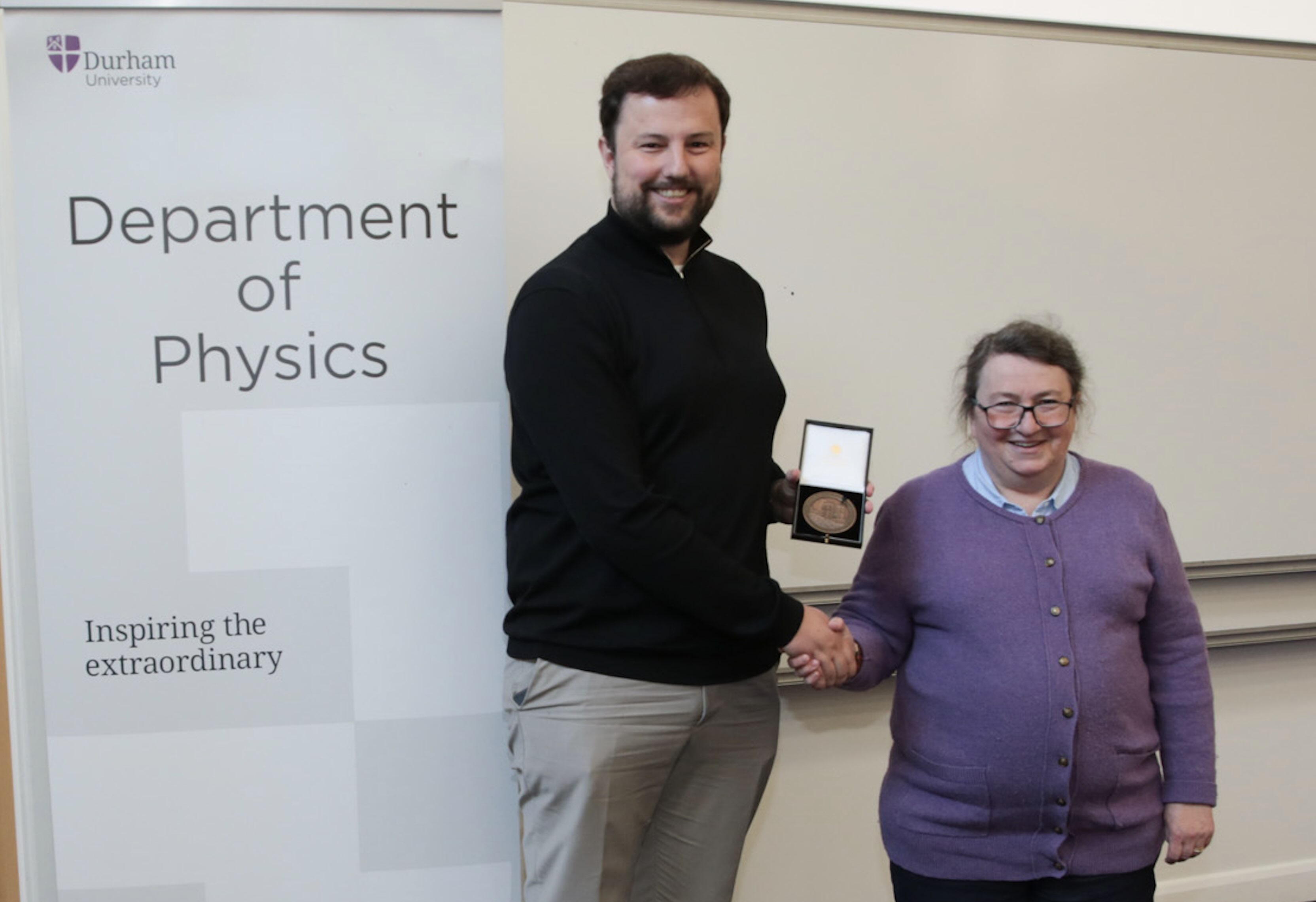 Roland Timmerman receiving a staff excellence award from Prof Paula Chadwick