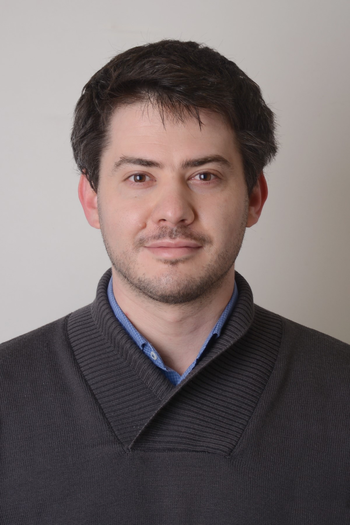 A headshot of Andrea Ghiselli with a plain background