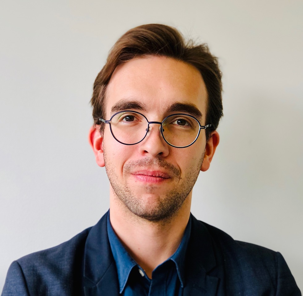 A portrait of a man with glasses