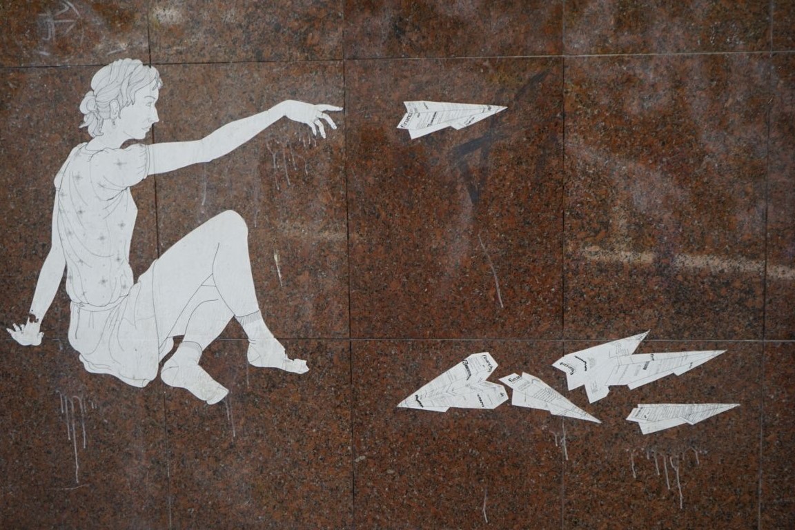 Image of figure throwing paper aeroplanes