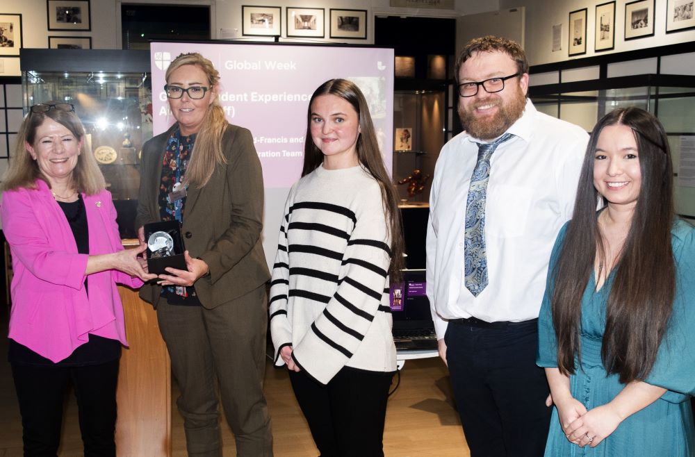 A group of people being presented with an award