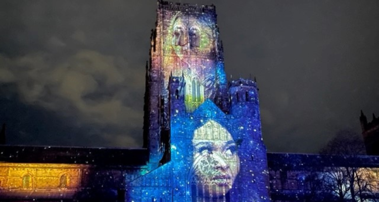 Durham Cathedral illuminated with a womans face