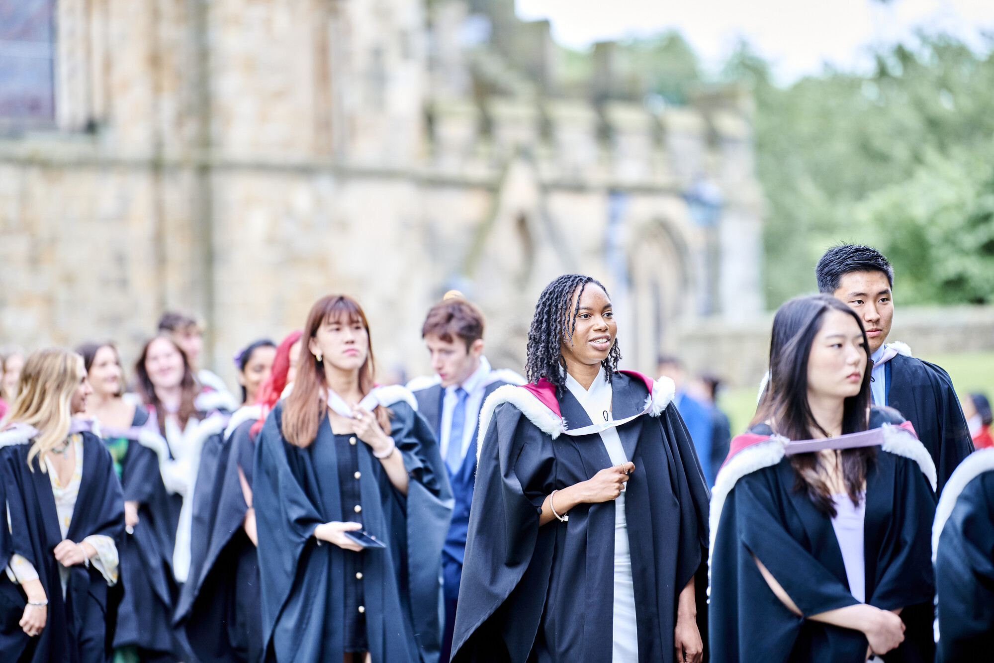 Graduates in robes exiting Durham Cathedral