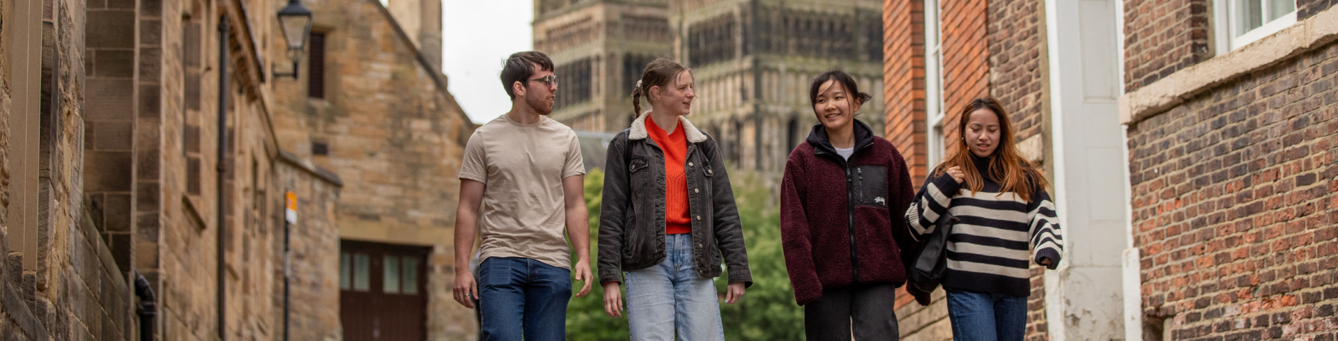 Students walking down a road with the Cathedral in the background
