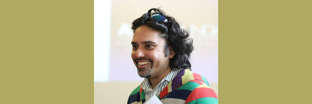 Durham academic Tufyal Choudhury is pictured with a slide presentation in background