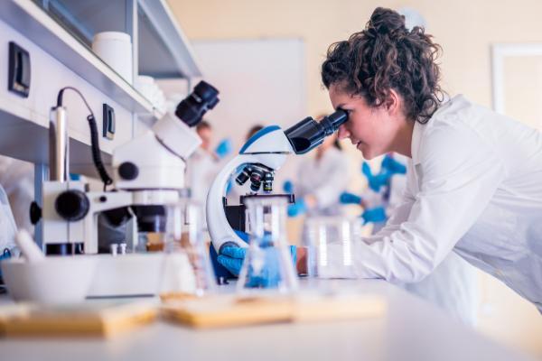Technicians looking in a microscope