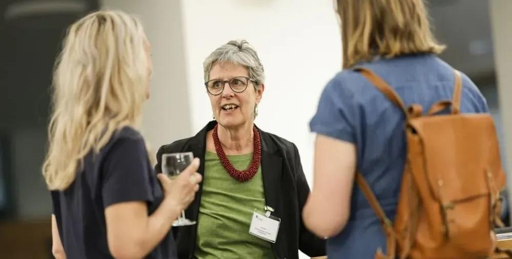 Three people deep in conversation