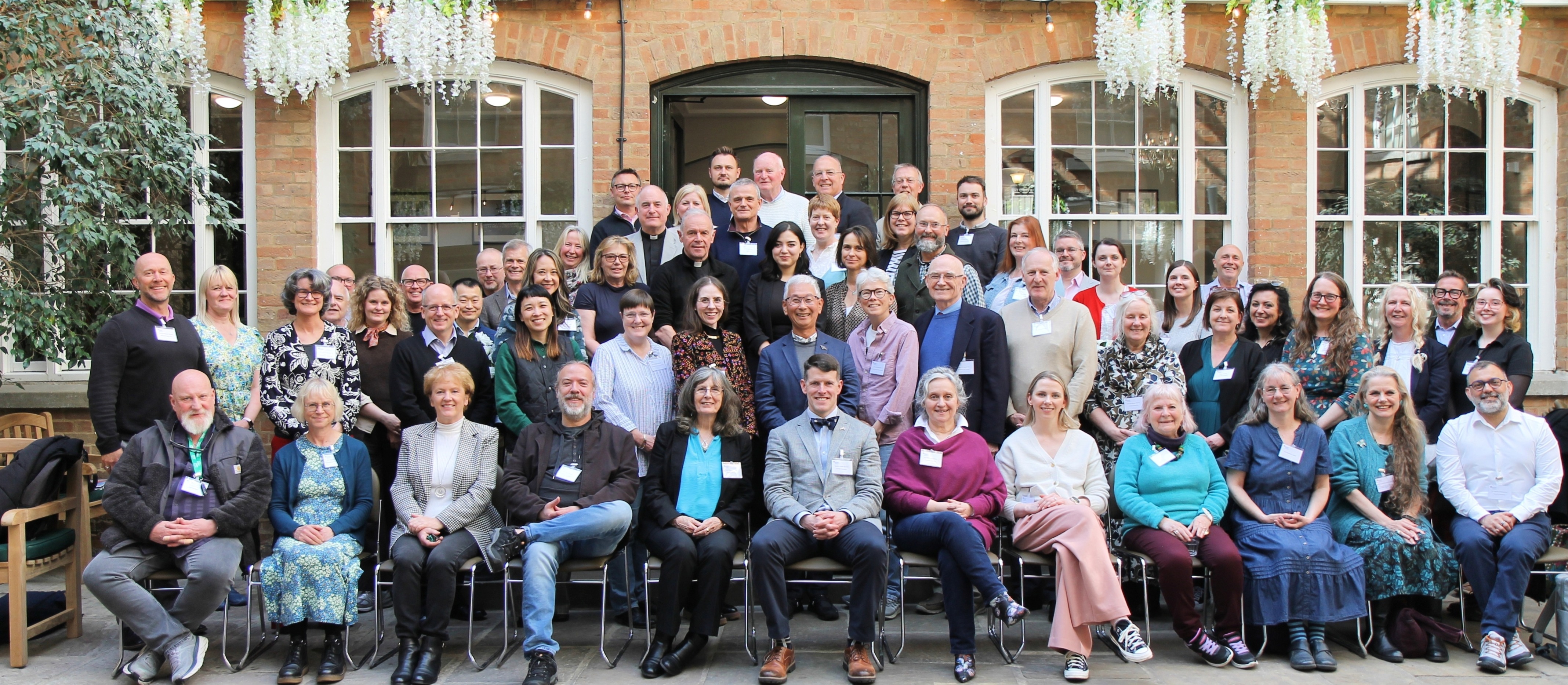 A group of around 70 smiling people