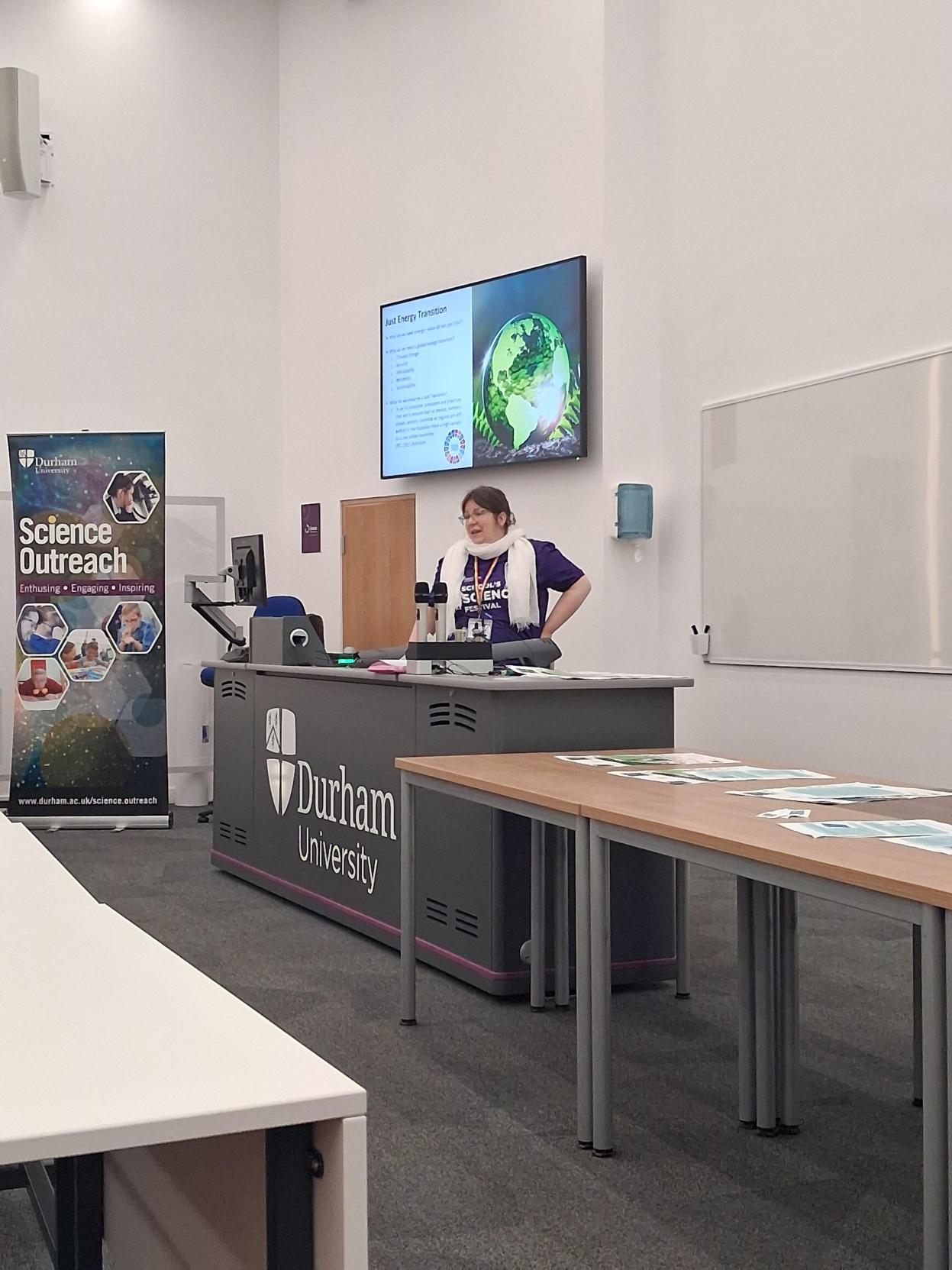A woman presenting to students