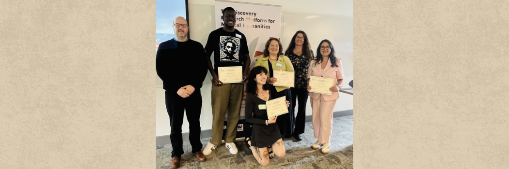 A group of researchers holding certificates.